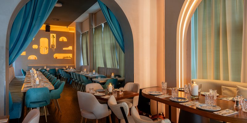 Kymata Modern - A stylish dining area with blue accents – Mediterranean ambience at Kymata Modern.