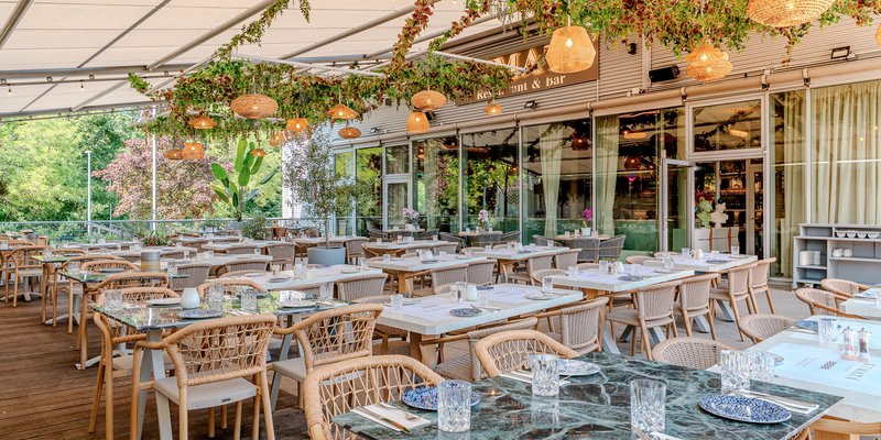 Kymata Modern - The terrace set for dining beneath the pergola – a Mediterranean setting for summer and company parties.